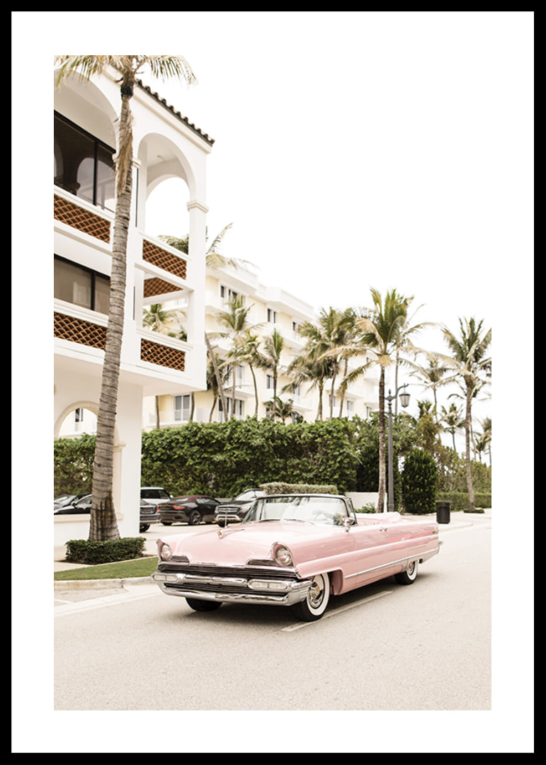 Photographic vintage car in pink in front of palm-lined buildings-12