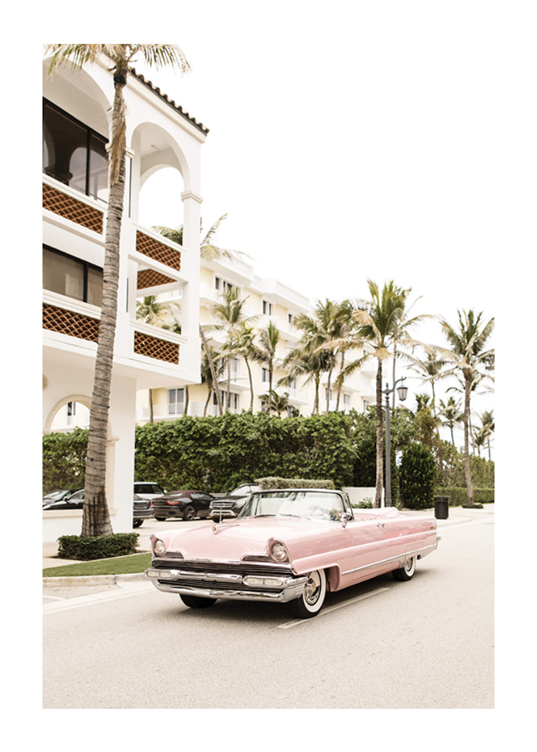 Photographic vintage car in pink in front of palm-lined buildings-12