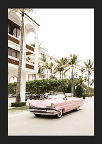 Photographic vintage car in pink in front of palm-lined buildings-5