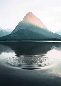 Photograph of water ripples on lake with mountains in the background-7