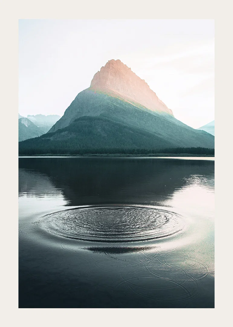 Photograph of water ripples on lake with mountains in the background-12