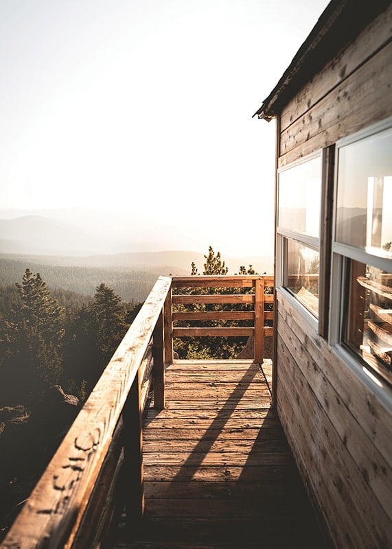 Photograph of wooden porch against sunset and forest in warm tones-12
