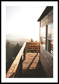 Photograph of wooden porch against sunset and forest in warm tones-0