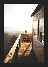 Photograph of wooden porch against sunset and forest in warm tones-5
