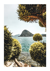 Photograph of lake landscape with treetops and mountains in the background-1