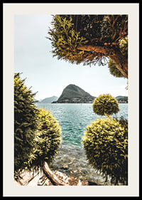 Photograph of lake landscape with treetops and mountains in the background-2