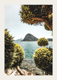 Photograph of lake landscape with treetops and mountains in the background-3