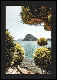 Photograph of lake landscape with treetops and mountains in the background-4