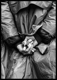 Black and white close-up of hands with cigarette behind back-6