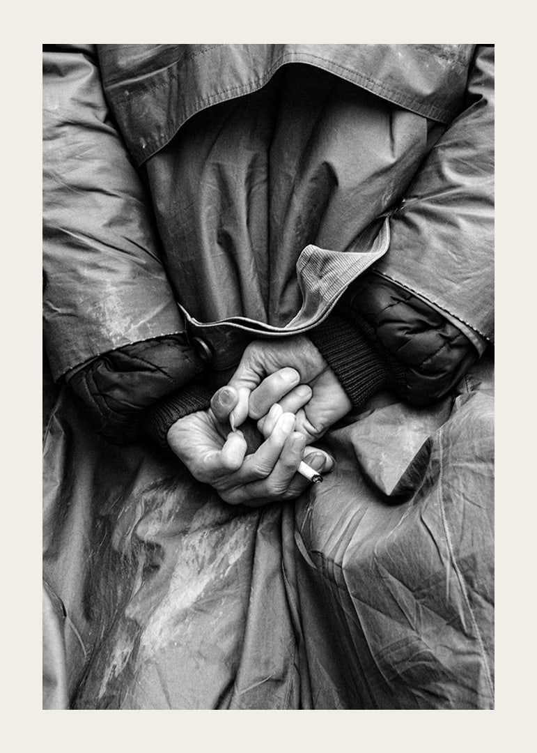 Black and white close-up of hands with cigarette behind back-12