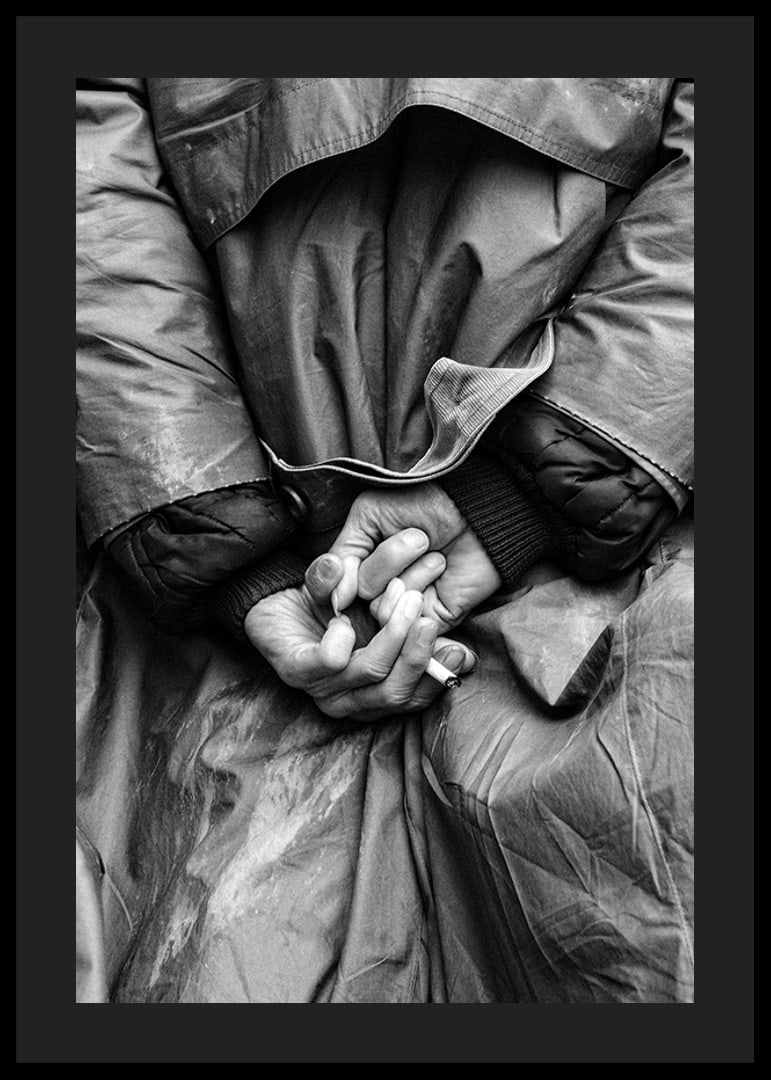 Black and white close-up of hands with cigarette behind back-12