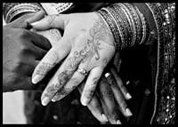 Black and white photo of hands decorated with henna and jewelry-6