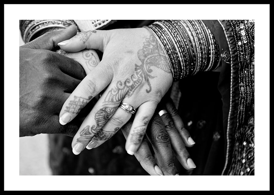 Black and white photo of hands decorated with henna and jewelry-12