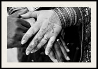Black and white photo of hands decorated with henna and jewelry-2