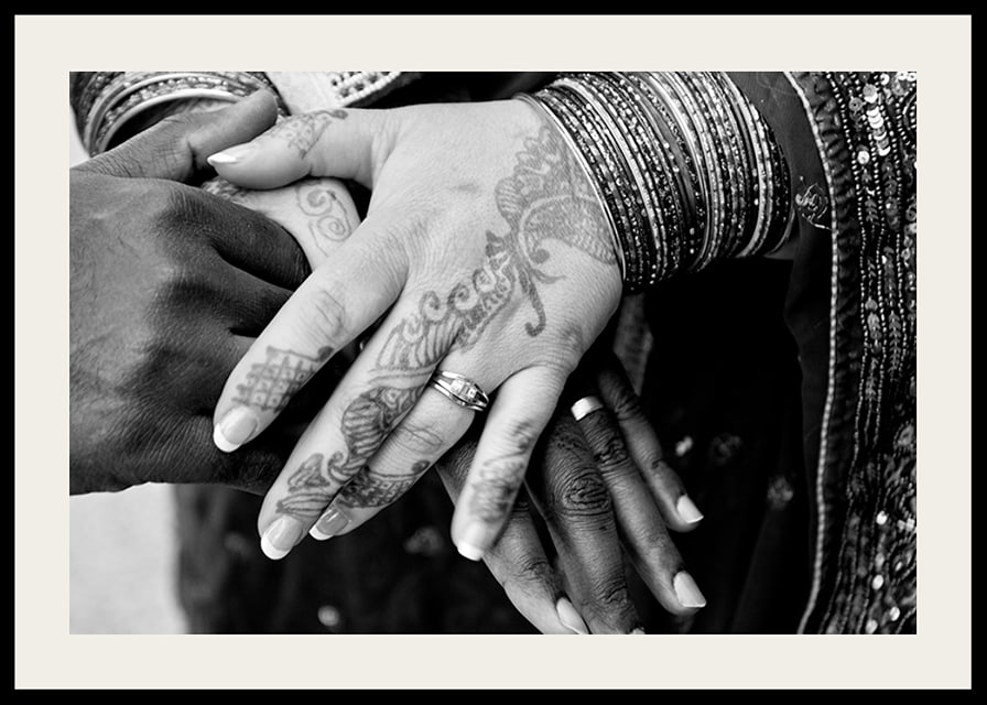 Black and white photo of hands decorated with henna and jewelry-12