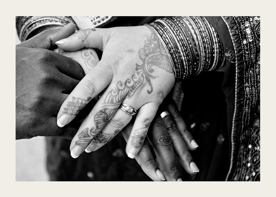 Black and white photo of hands decorated with henna and jewelry-12
