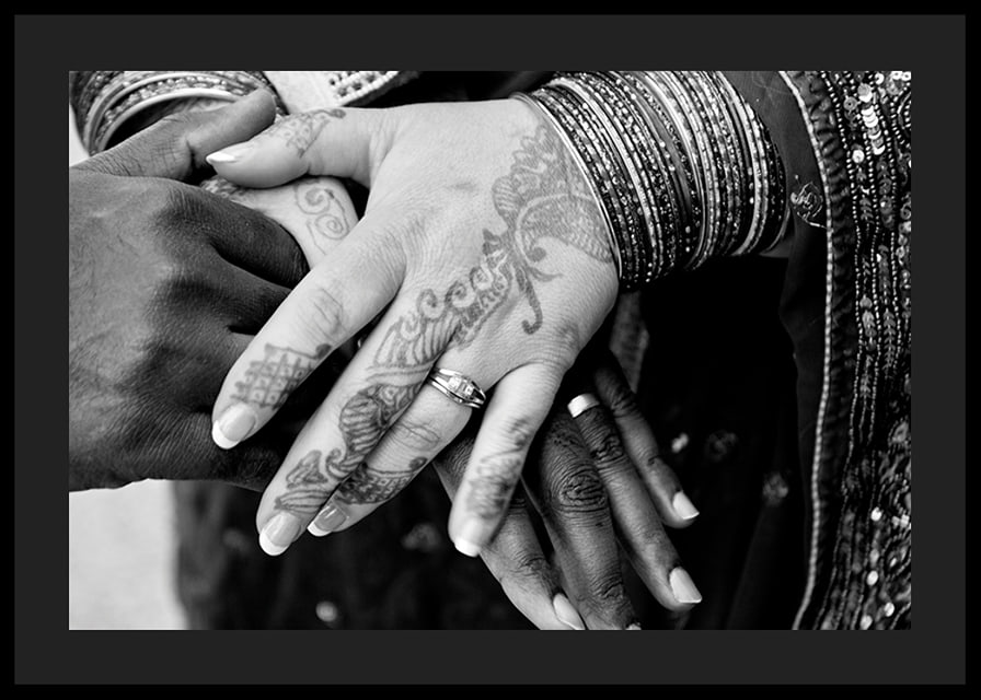 Black and white photo of hands decorated with henna and jewelry-12