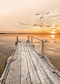Photograph of old wooden pier by still water at sunset-7