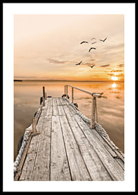 Photograph of old wooden pier by still water at sunset-0