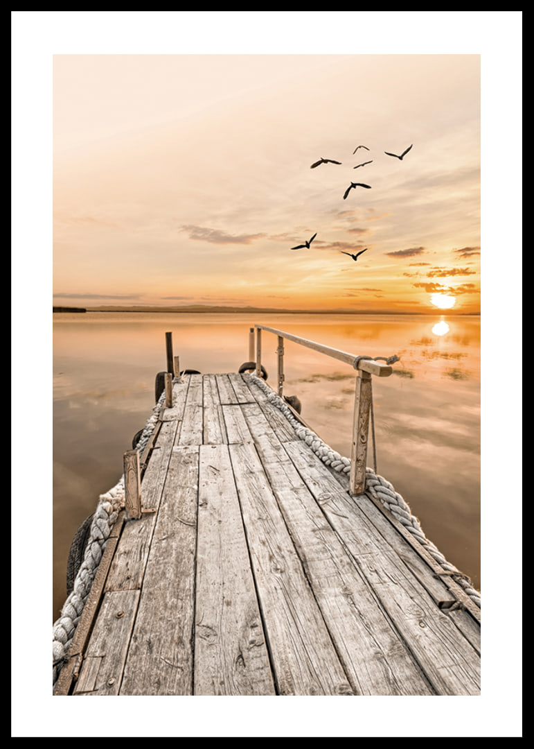 Photograph of old wooden pier by still water at sunset-12