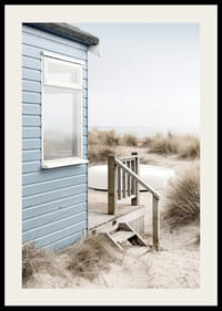 Photograph of light blue beach house by sand dunes and dry grass-2