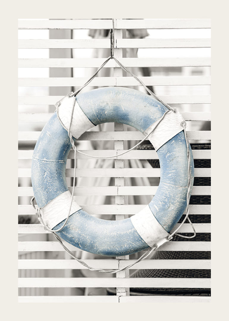Photograph of light blue lifebuoy against white wooden wall in retro style-12