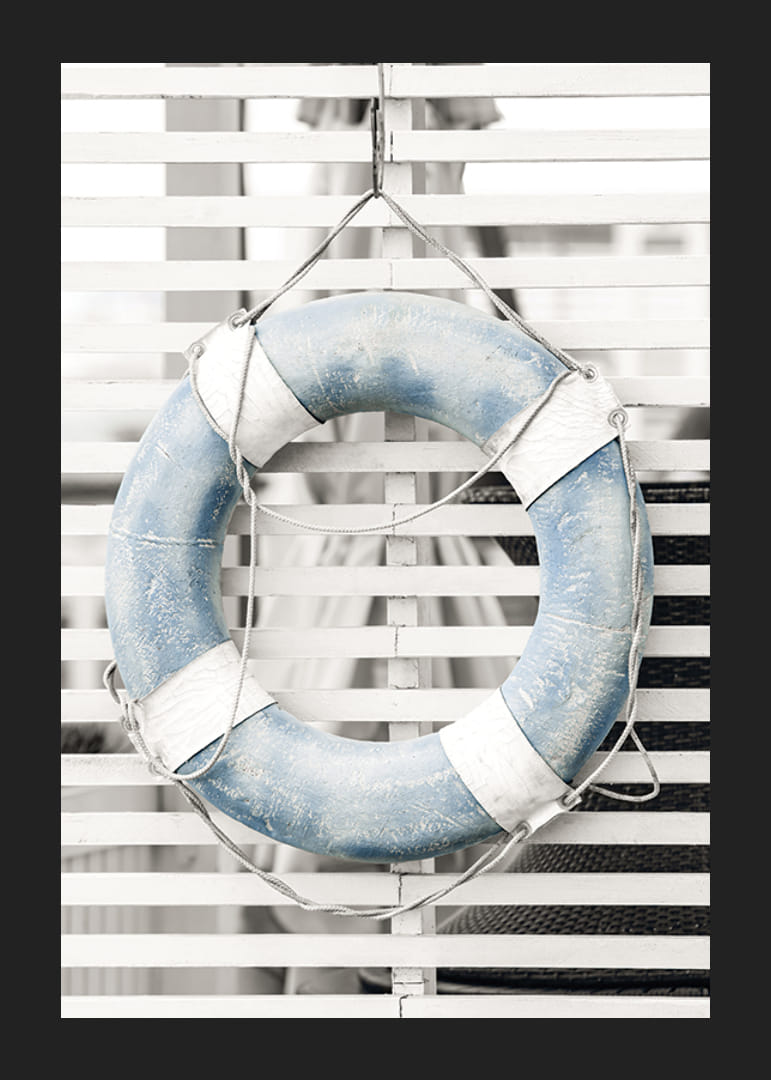 Photograph of light blue lifebuoy against white wooden wall in retro style-12