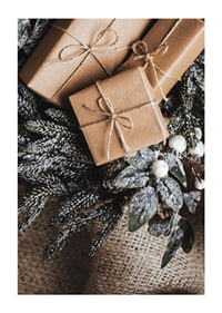 Brown Christmas presents with string on fir tree and jute fabric, close-up-1