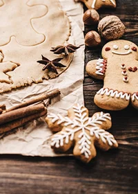 Close-up of gingerbread dough, star anise and decorated cookies-7