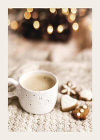 Zbliżenie filiżanki kawy i pierniczków na dzianinowym kocu-3