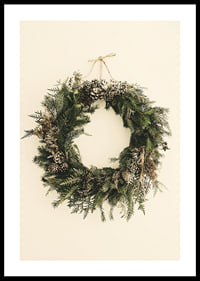 Photograph of green Christmas wreath with pine cones on beige background-0