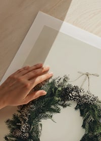 Photograph of green Christmas wreath with pine cones on beige background-9
