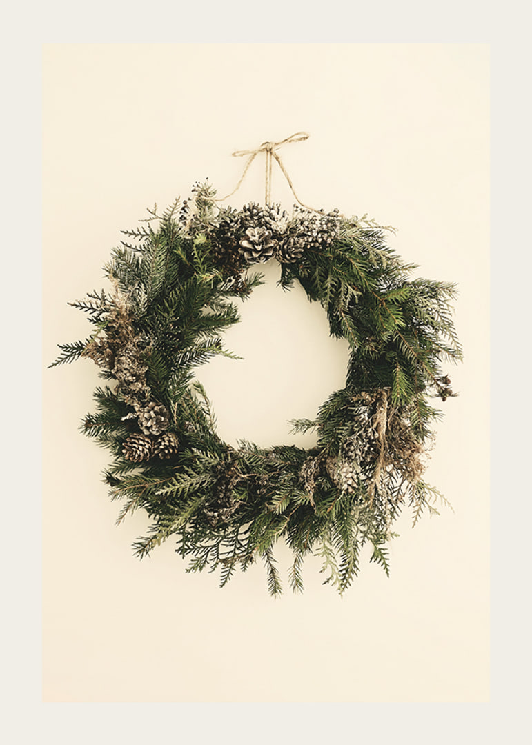 Photograph of green Christmas wreath with pine cones on beige background-12