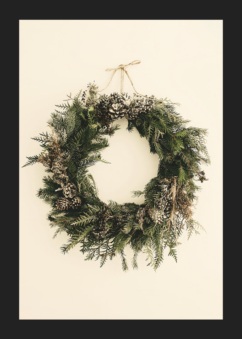 Photograph of green Christmas wreath with pine cones on beige background-12