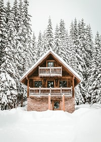 Wooden cottage surrounded by snow-covered fir trees in winter landscape-7