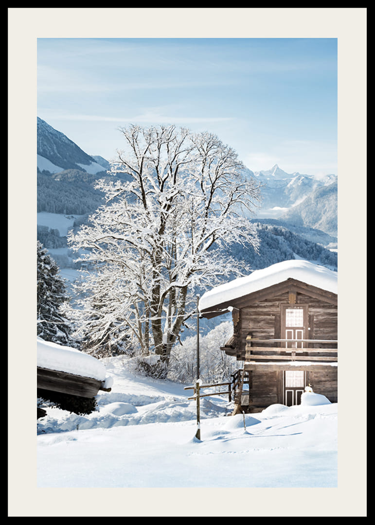 Photograph of wooden cabin in snow-covered mountain landscape and blue sky-12