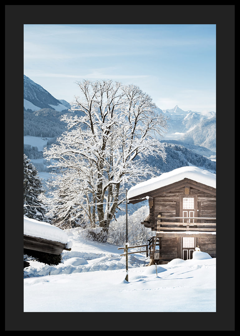 Photograph of wooden cabin in snow-covered mountain landscape and blue sky-12