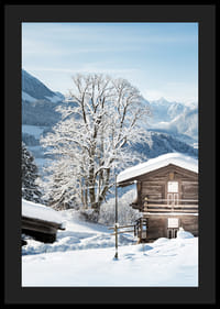 Photograph of wooden cabin in snow-covered mountain landscape and blue sky-4