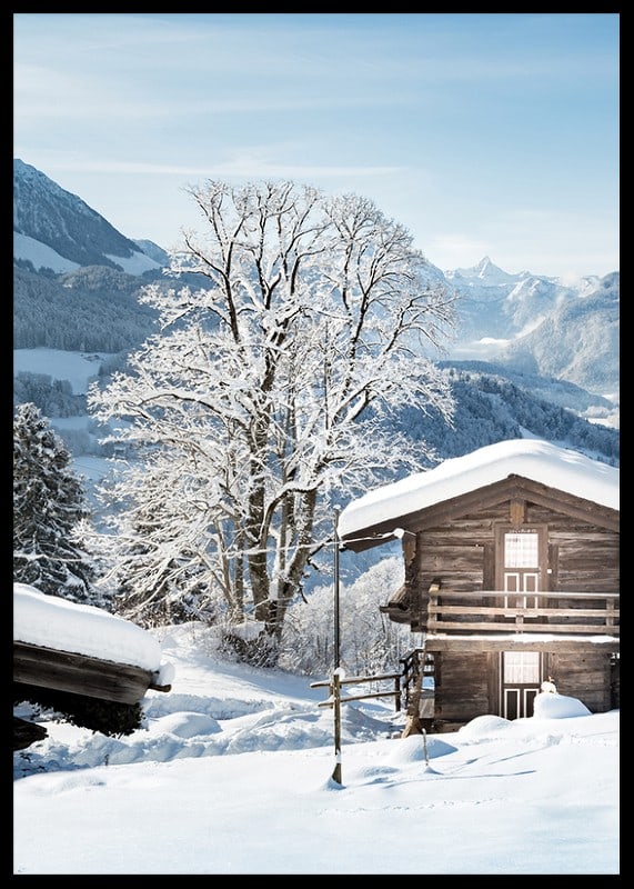 Photograph of wooden cabin in snow-covered mountain landscape and blue sky-12
