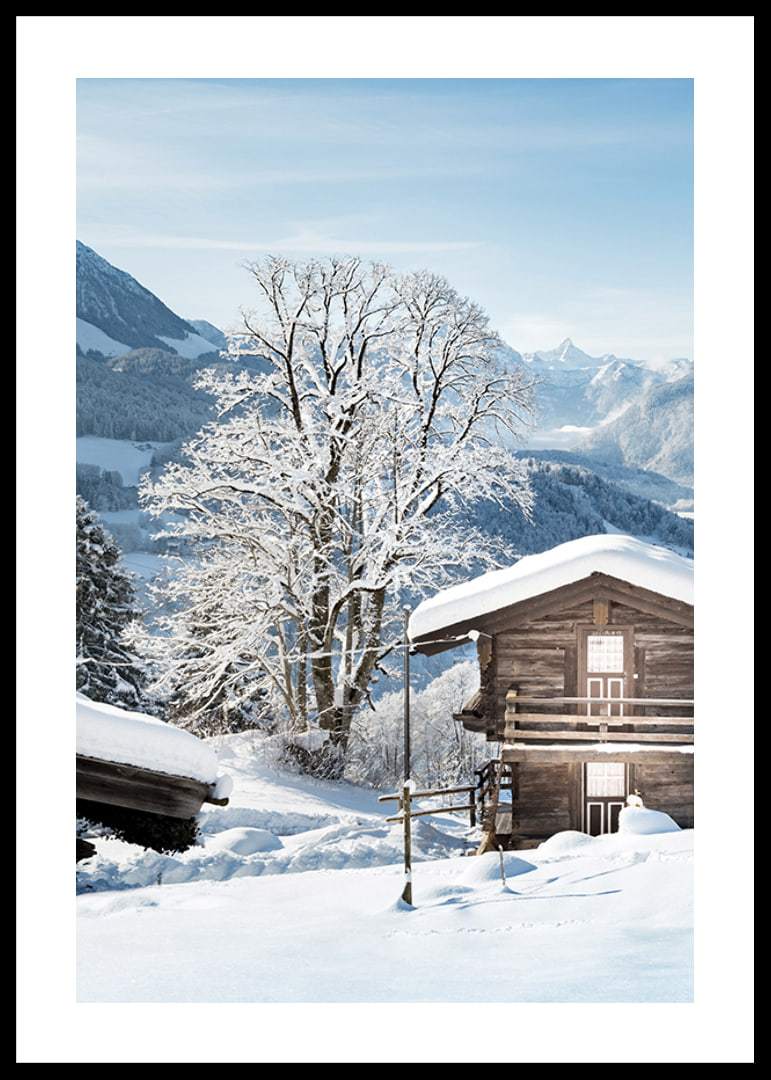 Photograph of wooden cabin in snow-covered mountain landscape and blue sky-12