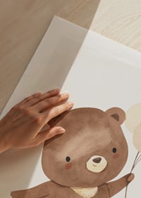 Illustrated brown bear cub with three balloons in beige tones-9