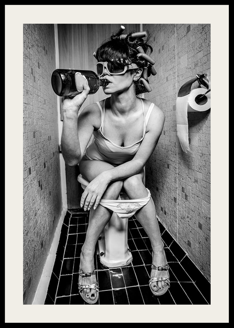 Black and white photo of woman with sunglasses in toilet-12