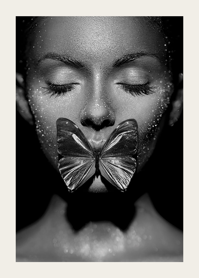 Black and white close-up portrait of woman with butterfly over mouth-12