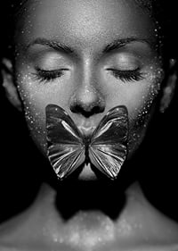 Black and white close-up portrait of woman with butterfly over mouth-7
