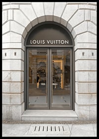 Store entrance with Louis Vuitton sign in stone facade, brown tones-6