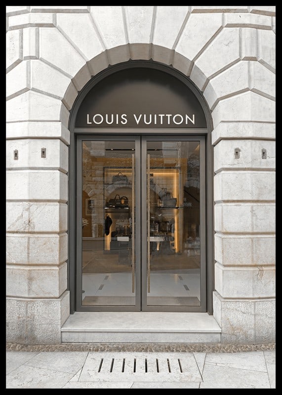 Store entrance with Louis Vuitton sign in stone facade, brown tones-12