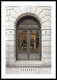 Store entrance with Louis Vuitton sign in stone facade, brown tones-0