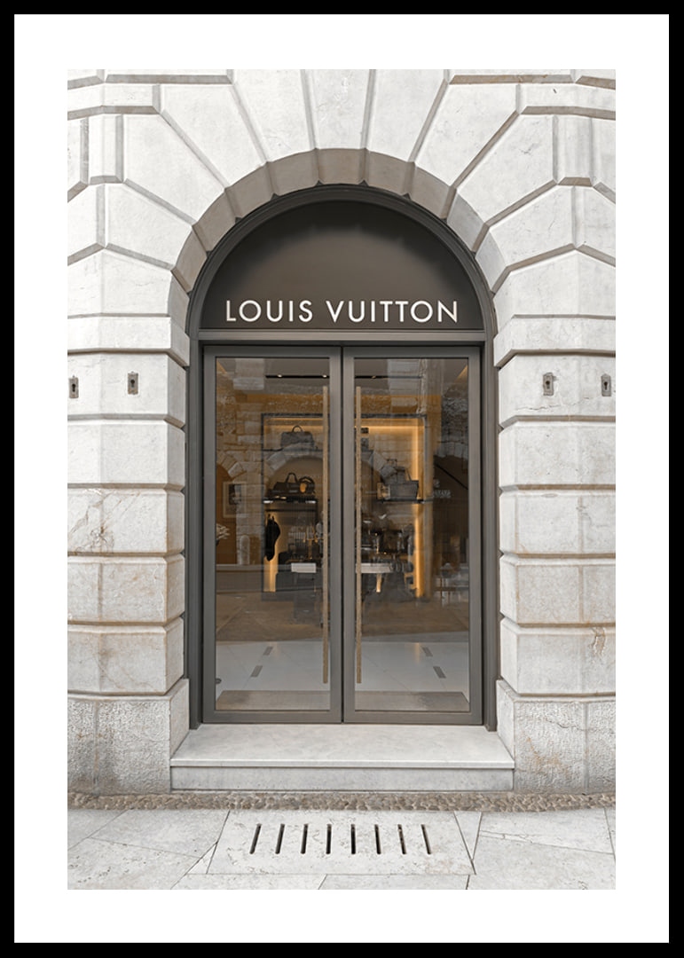 Store entrance with Louis Vuitton sign in stone facade, brown tones-12