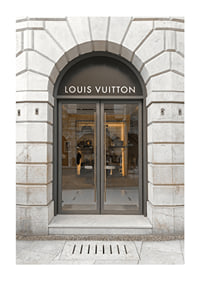 Store entrance with Louis Vuitton sign in stone facade, brown tones-1
