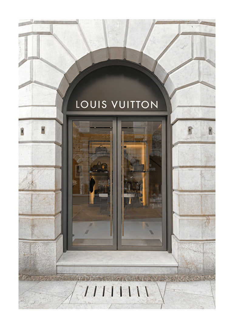 Store entrance with Louis Vuitton sign in stone facade, brown tones-12